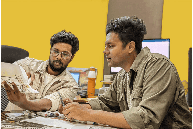 Sidhardh Baji and Krishna Raj reviewing an architectural sketch together at the studio